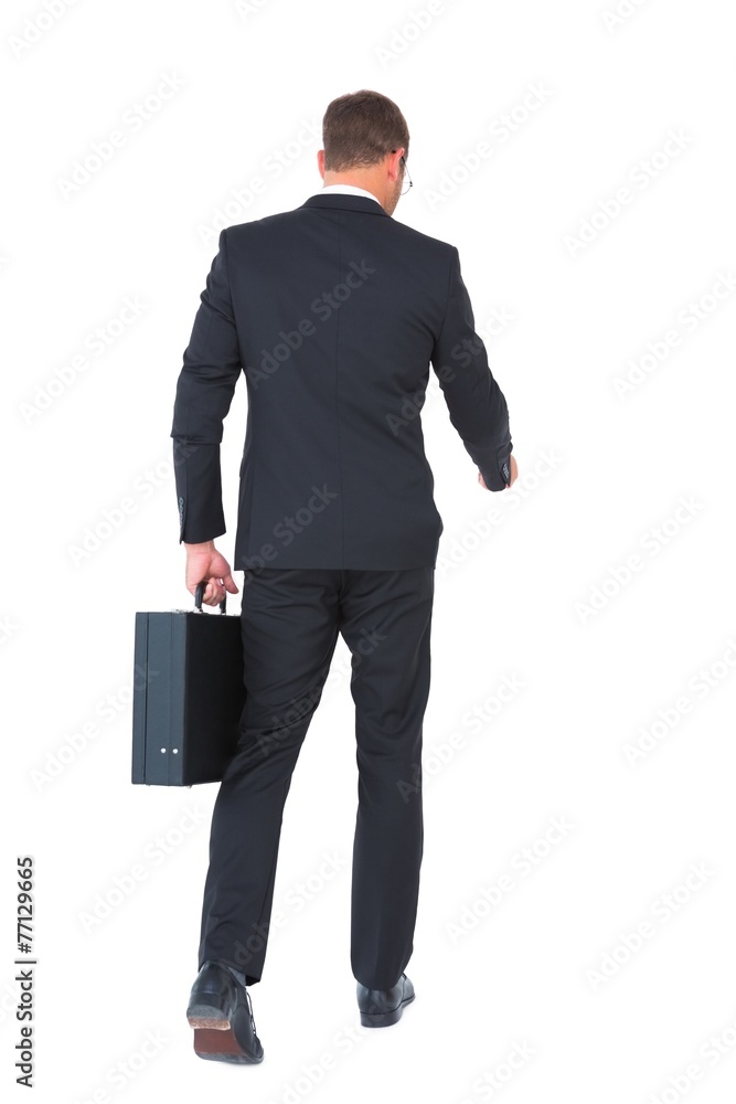 Businessman walking with his briefcase Businessman walking with his briefcase