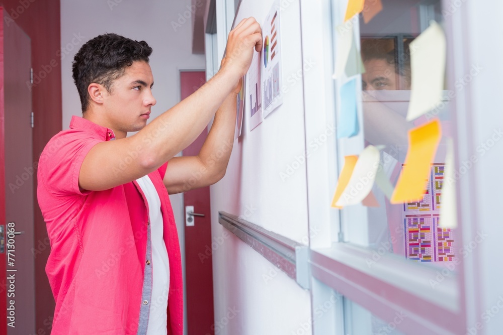 Student putting graphics on the wall Student putting graphics on the wall