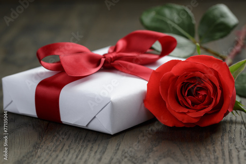 present box with ribbon bow and rose