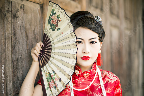 Obraz na plátně Chinese woman red dress traditional cheongsam ,close up portrait