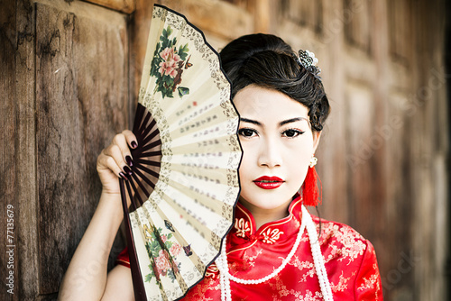 Fotografie Chinese woman red dress traditional cheongsam ,close up portrait