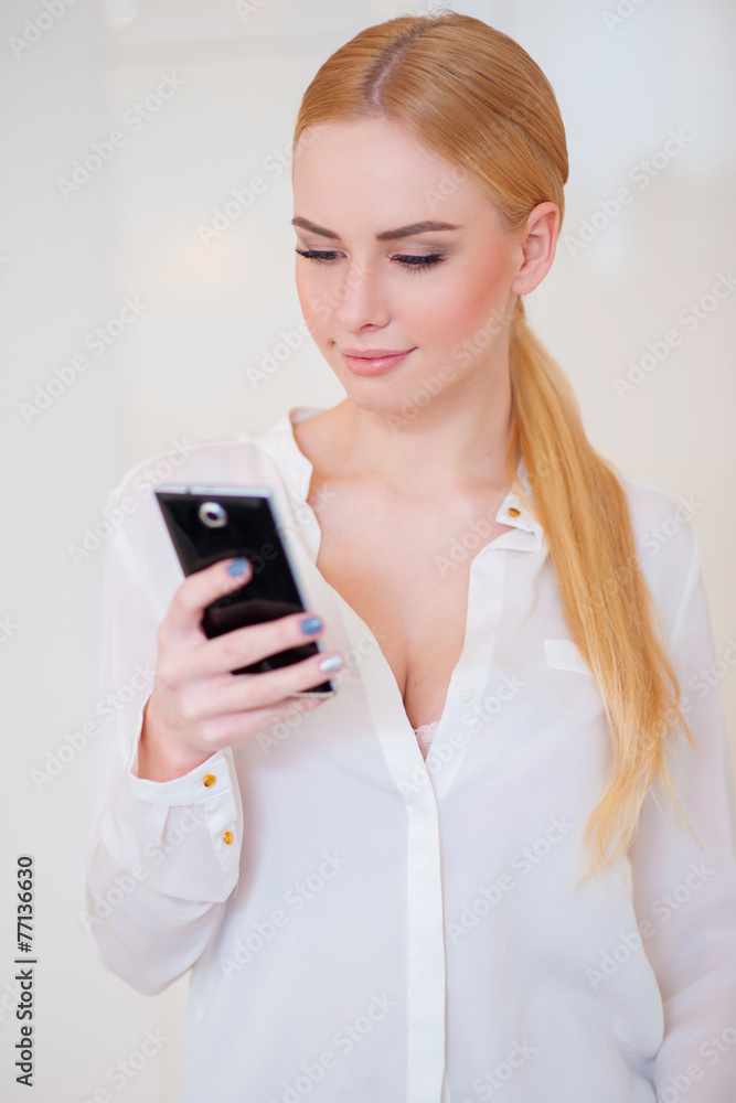 Smiling Blond Woman Using her Mobile Phone Smiling Blond Woman Using her Mobile Phone