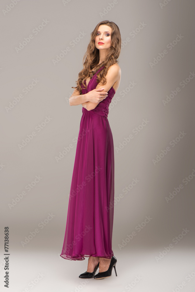 Young woman with curly hair wearing evening dress