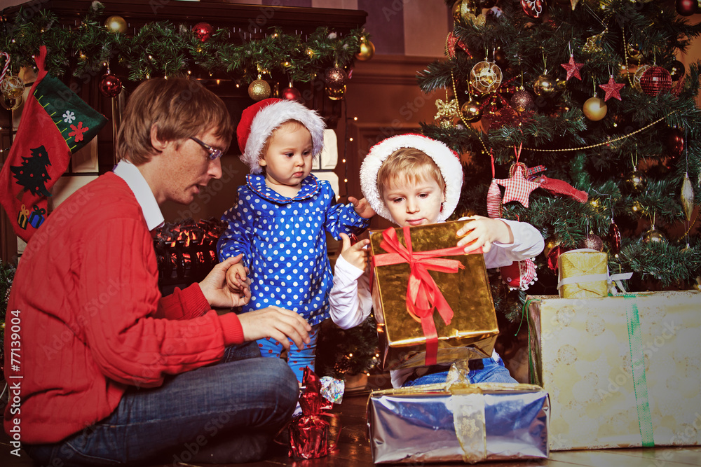 father and kids with presents in christmas father and kids with presents in christmas