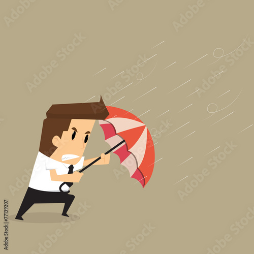 businessman holding an umbrella in the middle of a rainstorm