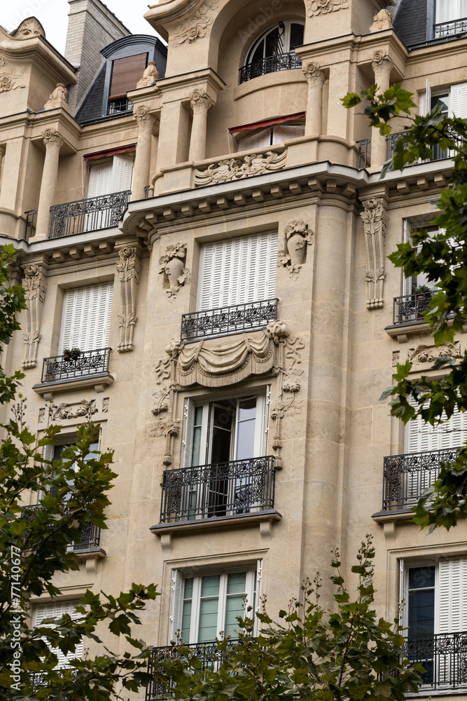 facade of typical house with balcony in Paris, France