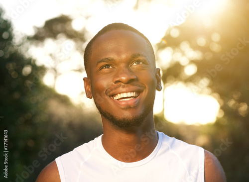 Happy young african american man smiling outdoors © mimagephotos