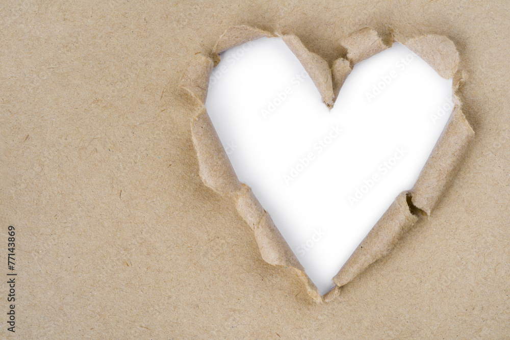 Heart shaped torn through recycled paper Heart shaped torn through recycled paper