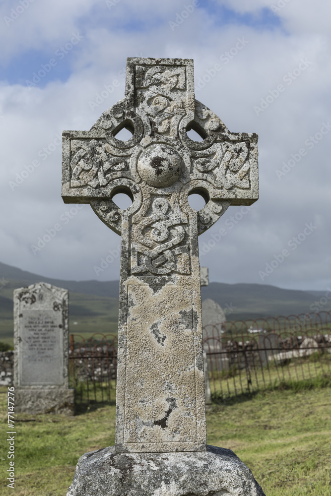 Old carved stone Celtic cross in London cemetery, UK