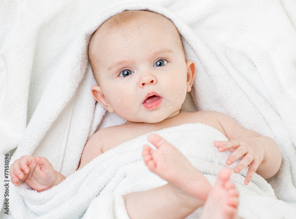 Cute baby girl lying on white towel Cute baby girl lying on white towel
