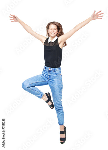 Happy young teenager girl jumping isolated