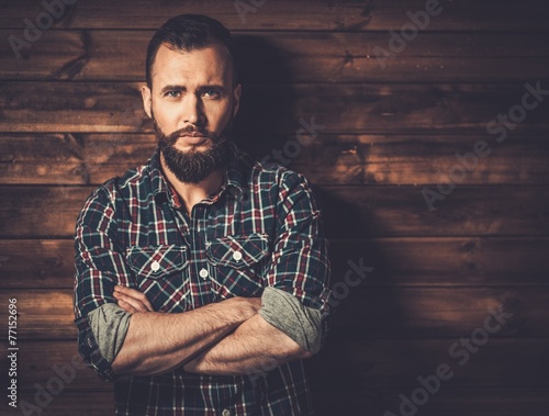 Man wearing checkered shirt in wooden rural house