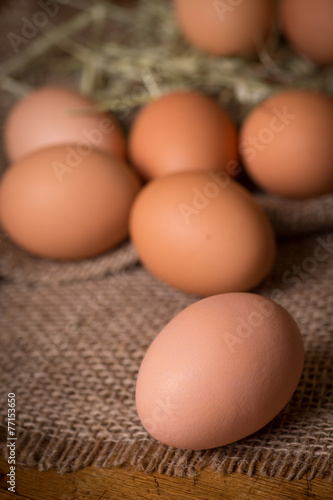 Organic brown eggs in rustic setting