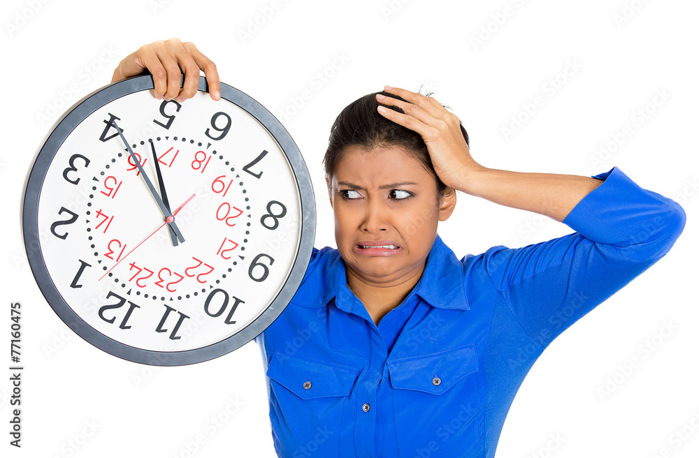 Stressed young woman running out of time holding clock Stressed young woman running out of time holding clock
