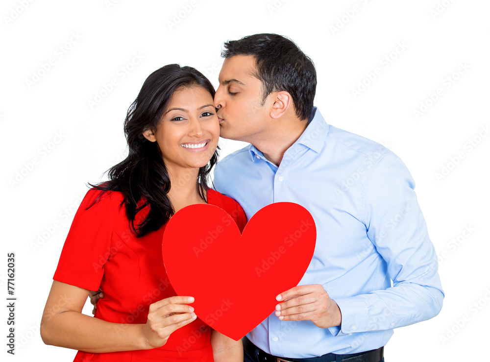 man happily giving red heart and kissing pretty beautiful woman