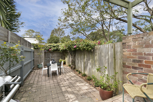 private green, level fenced yard with sitting arrangement