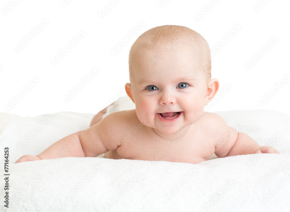 Cute smiling baby lying on white towel Cute smiling baby lying on white towel