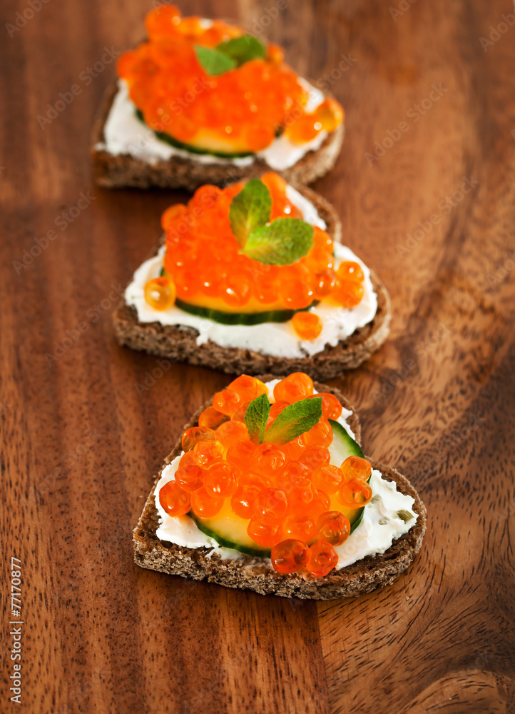 Heart shaped toasts with red caviar Heart shaped toasts with red caviar