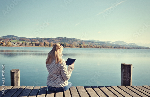 Girl reading from a tablet 