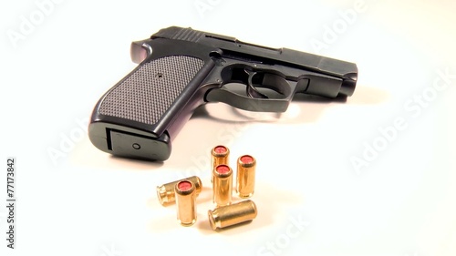 Semi-automatic handgun with golden teargas cartridges photo