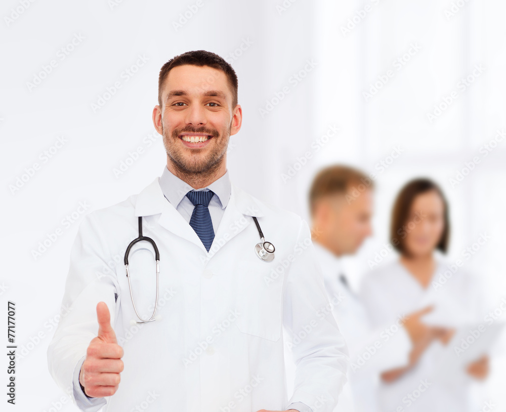 smiling doctor with stethoscope showing thumbs up smiling doctor with stethoscope showing thumbs up