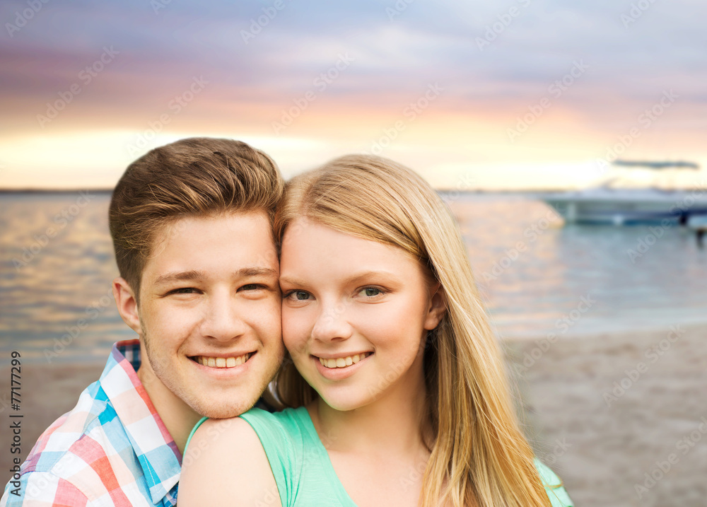 smiling couple hugging over beach background smiling couple hugging over beach background