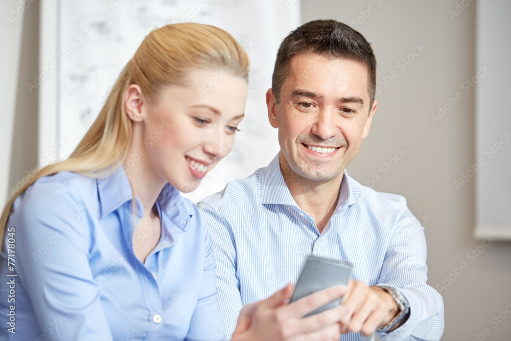 smiling businesspeople with smartphones in office smiling businesspeople with smartphones in office