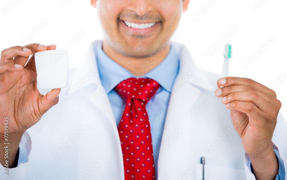 Closeuop dentist holding a toothbrush and dental floss Closeuop dentist holding a toothbrush and dental floss