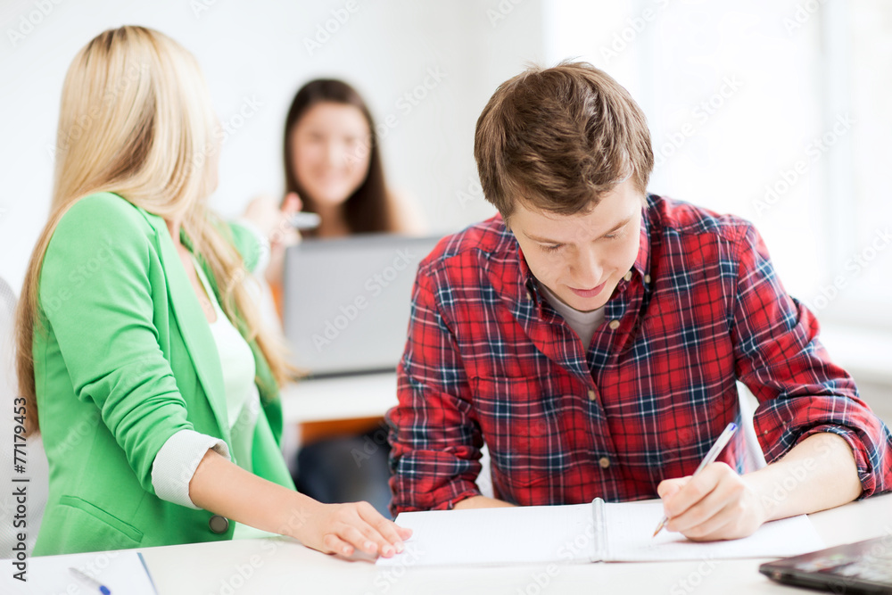 students writing something at school students writing something at school