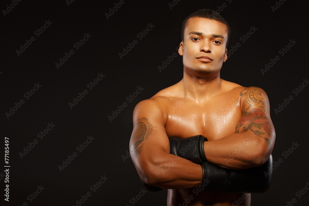 Fototapeta premium Handsome boxer posing in boxing gloves
