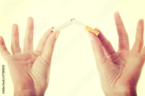 Broken cigarette in woman's hands.