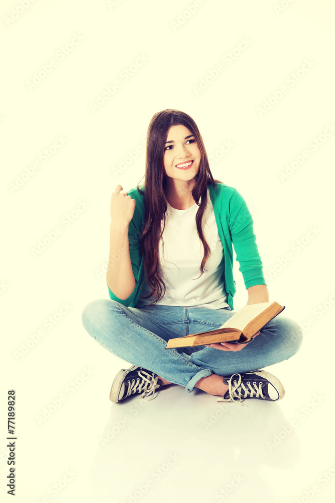 Young student sitting with book, reading. Young student sitting with book, reading.