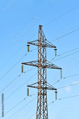 Electric lines pylon on blue sky background