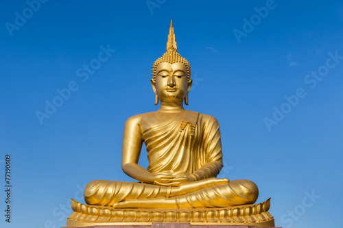 big golden buddha statue sitting in thai temple