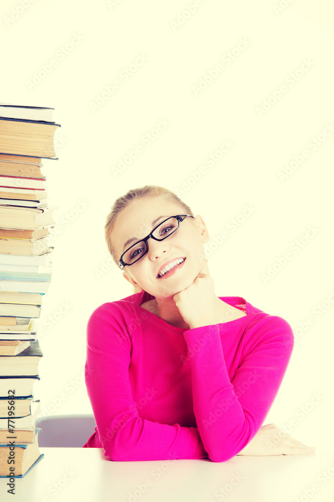 Young happy student with stack of books. Young happy student with stack of books.