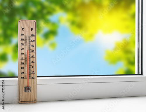 thermometer on the windowsill on the background of the summer he
