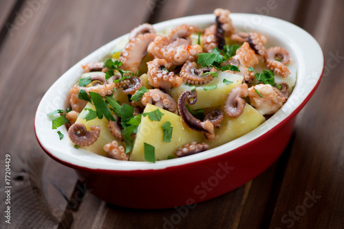 Italian salad with chopped octopus, potato and parsley