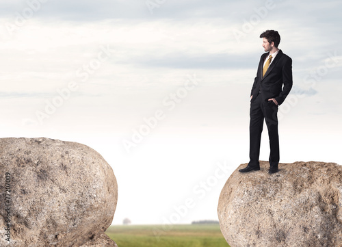 Businessman on rock mountain