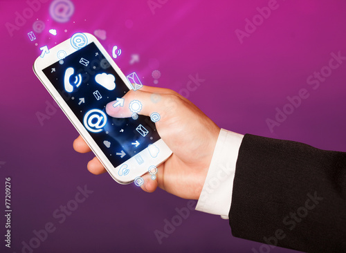 Business man holding smart phone with media icons