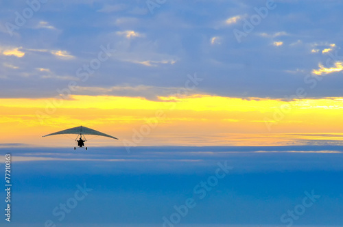 motor hang glider in the cloudy sunset