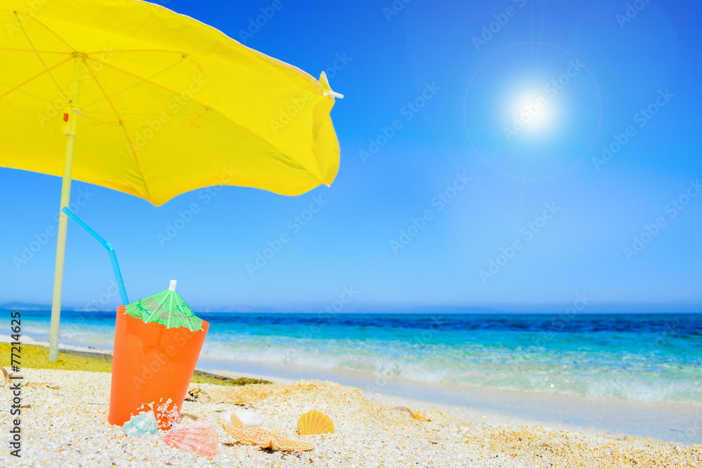 umbrella and cocktail under a shining sun umbrella and cocktail under a shining sun