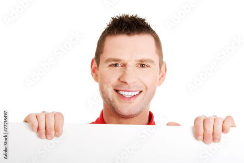 Happy man showing and displaying placard