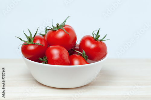 red tomatoes on wooden table
