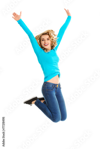 Young casual woman, student jumping.