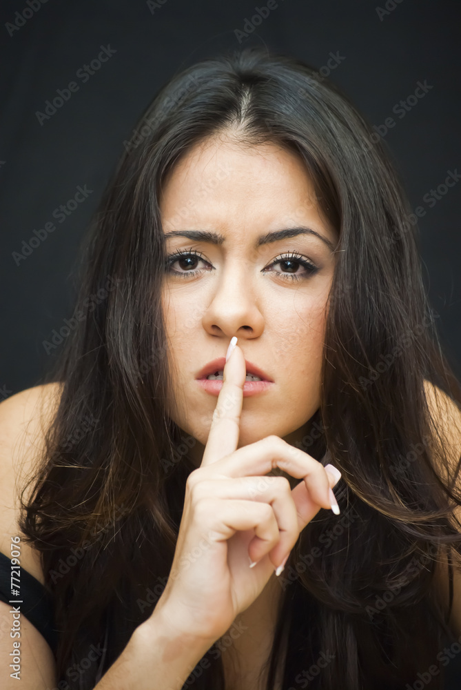 Beautiful Woman making the gesture of sending silence Beautiful Woman making the gesture of sending silence