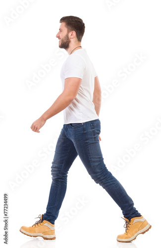 Man walking in jeans and white t-shirt