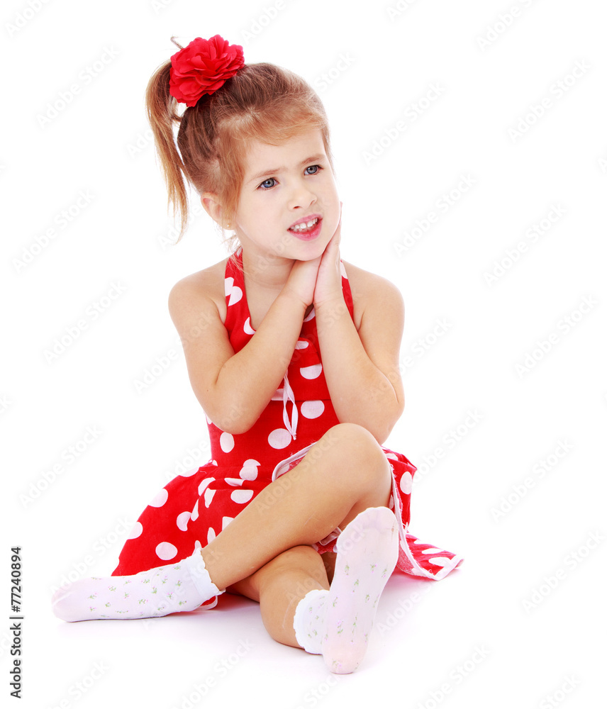 Beautiful little girl sitting on the floor crossed her legs. Stock Photo |  Adobe Stock