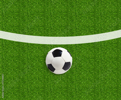 Soccer ball on green field grass