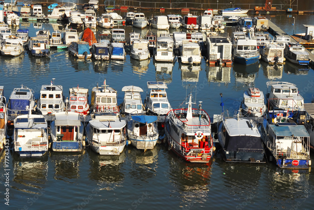 Various parked boats in row