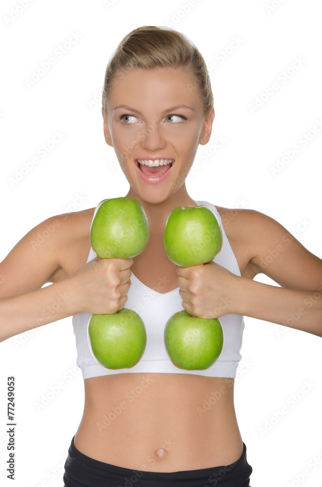 woman with dumbbells from ripe apples looking away woman with dumbbells from ripe apples looking away